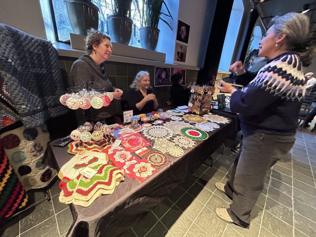 View of Helen Bickle's table with crochet work spread on it.